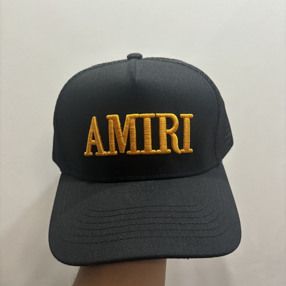 Amiri's black baseball cap with yellow lettering